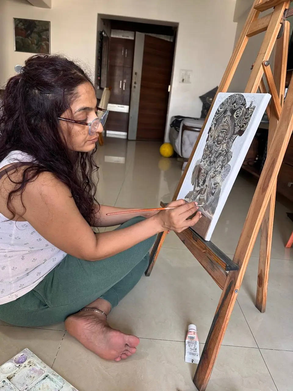 Vibhuti Mehta painting at the easel in her studio